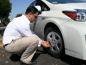 Drivers checking his car