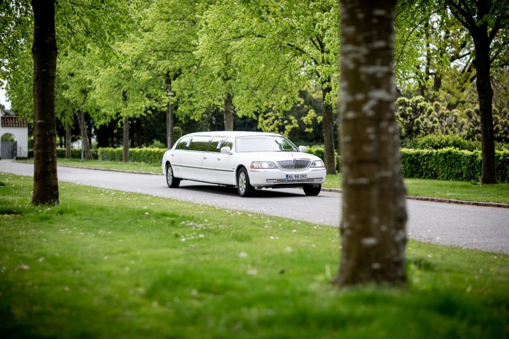 white limousine driving on road