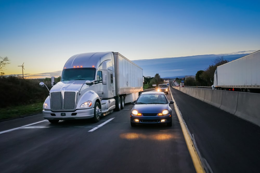 semi truck next to a car